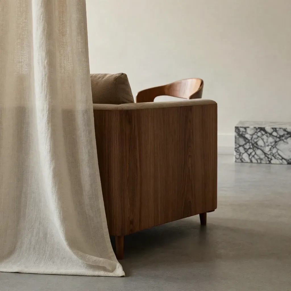 Sunlit lounge corner with linen drapery, marble plinth and oak chair edge, open space for copy.